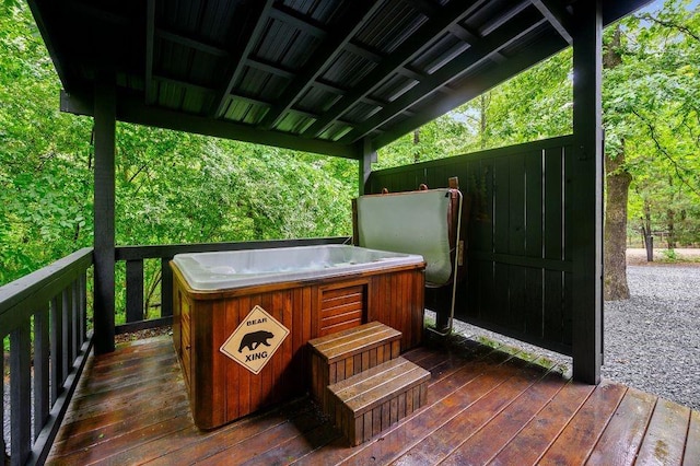 wooden deck featuring a hot tub