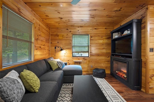 living room with dark hardwood / wood-style flooring, wooden ceiling, and wood walls