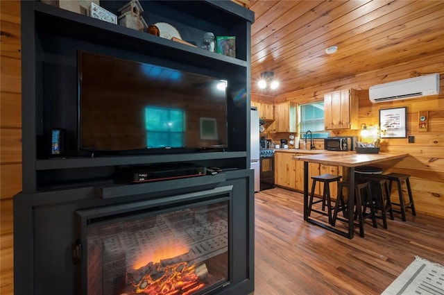 interior space with a wall mounted AC, range with electric stovetop, wood walls, wood counters, and a kitchen breakfast bar