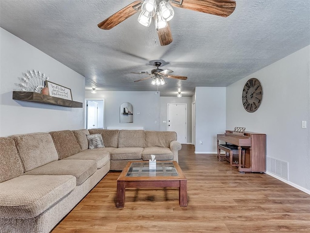 living room with a textured ceiling and hardwood / wood-style floors