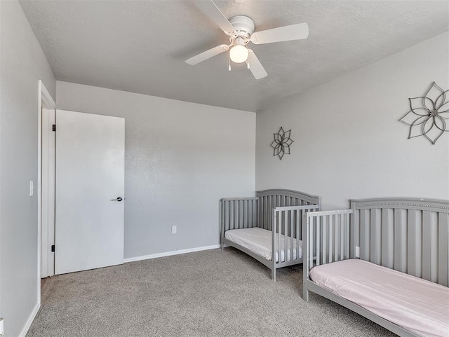 bedroom featuring a textured ceiling, ceiling fan, and carpet