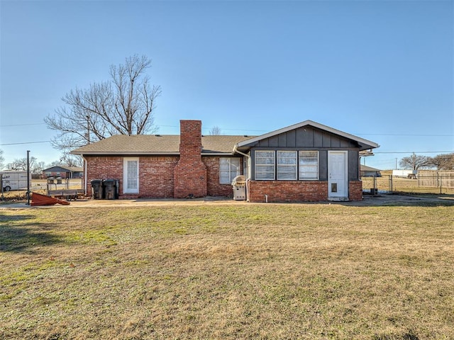 rear view of house featuring a yard