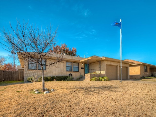 ranch-style home with a front lawn and a garage