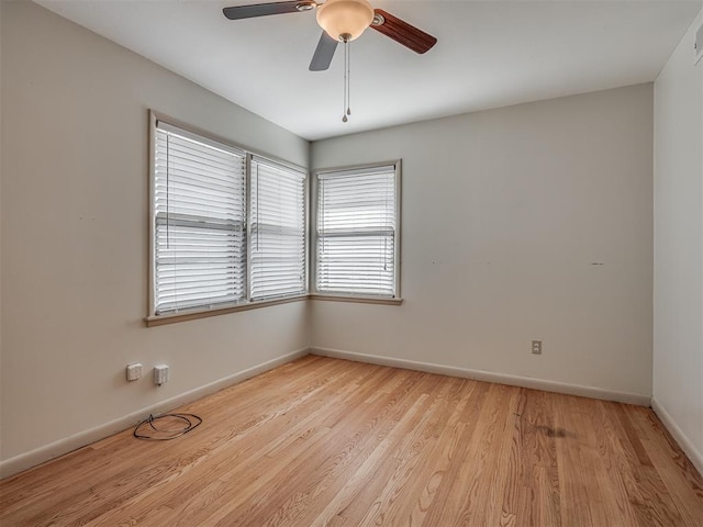 empty room with ceiling fan and light hardwood / wood-style floors