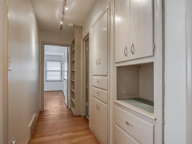 hall with light hardwood / wood-style floors