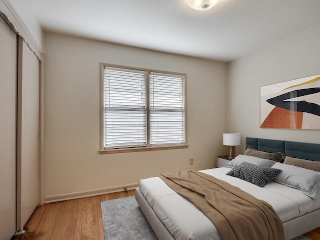 bedroom featuring a closet and light hardwood / wood-style flooring