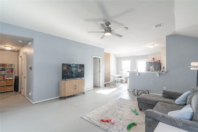 living room featuring ceiling fan and vaulted ceiling