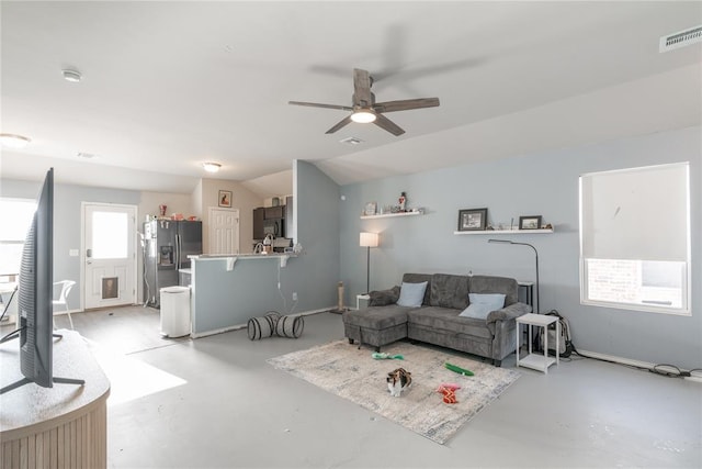 living room with ceiling fan and lofted ceiling