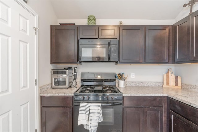 kitchen featuring black appliances, dark brown cabinets, light stone counters, and vaulted ceiling