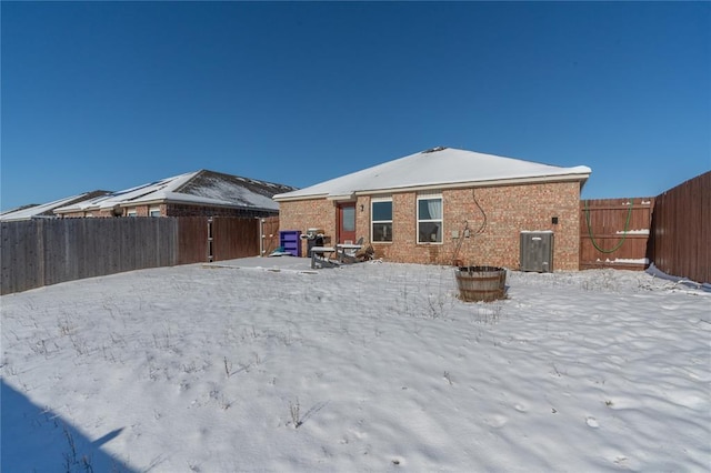 view of snow covered back of property