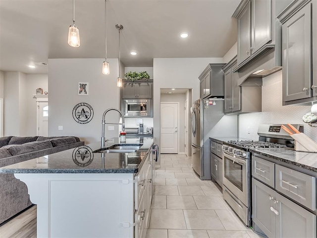 kitchen with sink, decorative light fixtures, light tile patterned floors, gray cabinets, and appliances with stainless steel finishes