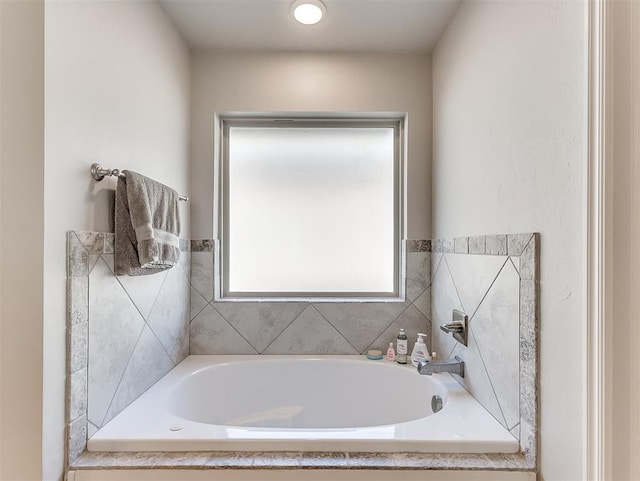 bathroom with tiled bath