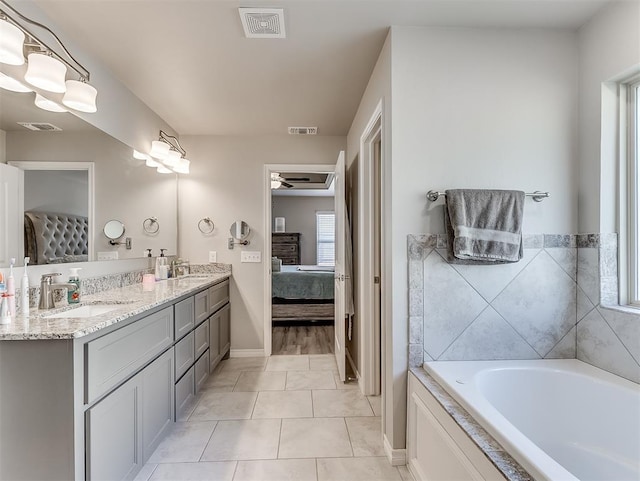 bathroom with a bathing tub, ceiling fan, tile patterned floors, and vanity