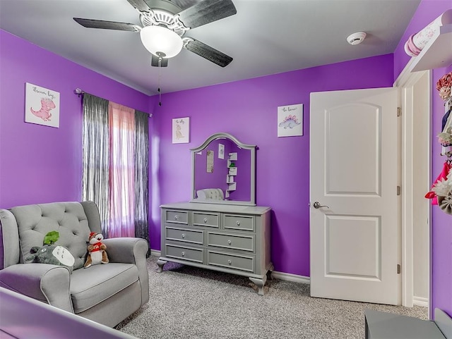 sitting room with ceiling fan and light carpet