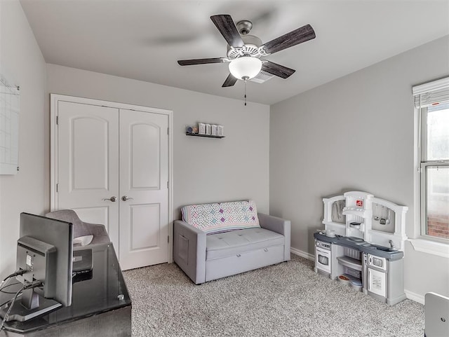 interior space with ceiling fan and light carpet