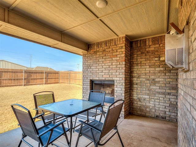 view of patio featuring an outdoor brick fireplace