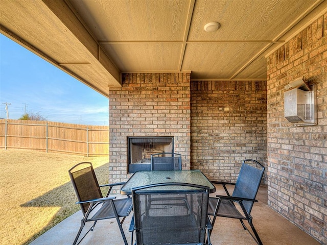 view of patio / terrace with an outdoor brick fireplace