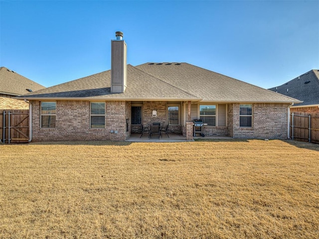 back of property featuring a patio and a lawn