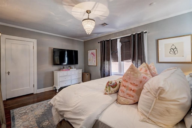 bedroom featuring ornamental molding, dark wood-type flooring, and an inviting chandelier