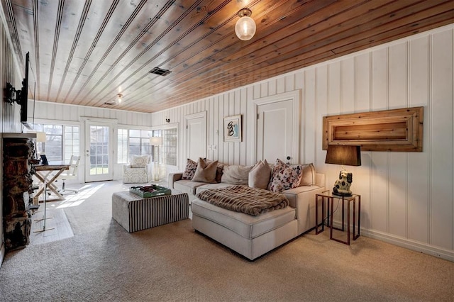 carpeted living room featuring french doors and wooden ceiling