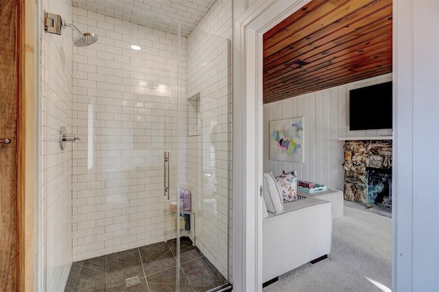 bathroom featuring wood ceiling and a shower with shower door