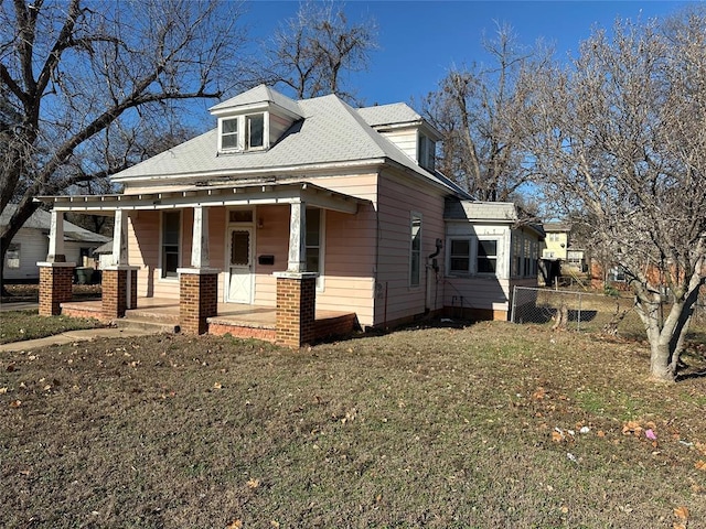 view of front of property with covered porch and a front yard