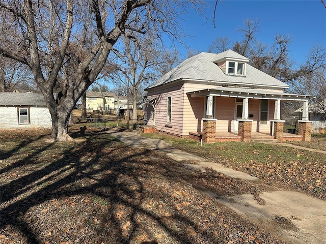 view of side of property with a porch