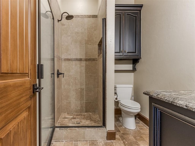 bathroom featuring walk in shower, vanity, and toilet