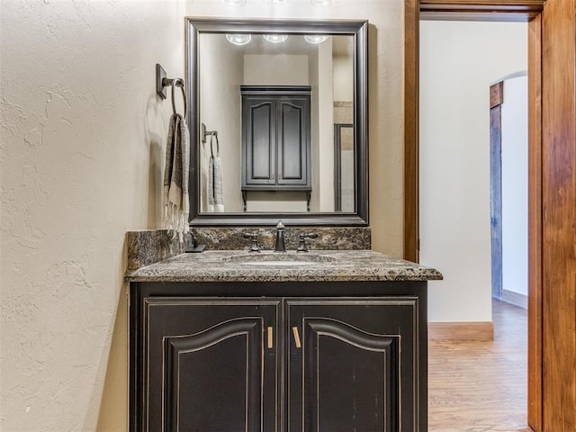 bathroom featuring hardwood / wood-style flooring and vanity