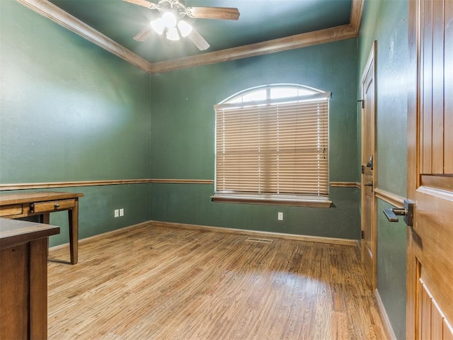 spare room featuring light hardwood / wood-style flooring, ornamental molding, and ceiling fan