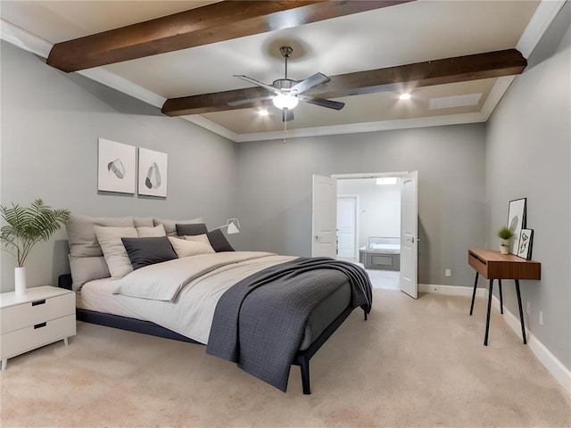 bedroom featuring ensuite bathroom, light colored carpet, ceiling fan, and beam ceiling