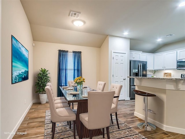 dining space featuring lofted ceiling