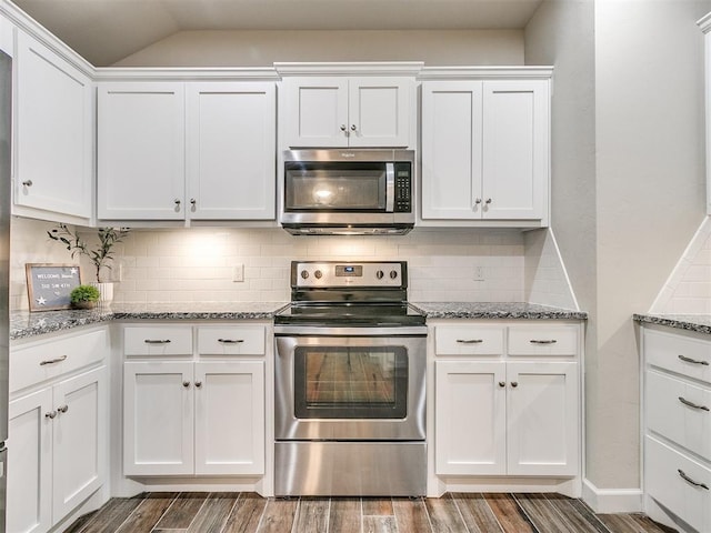 kitchen featuring white cabinetry, light stone counters, and appliances with stainless steel finishes