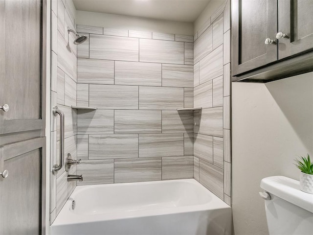 bathroom with toilet and tiled shower / bath combo