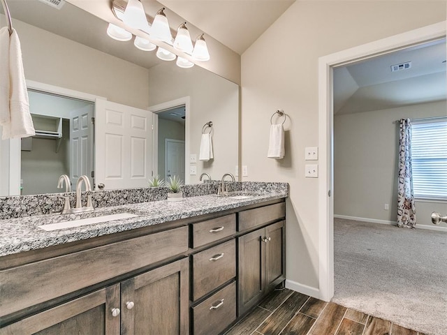 bathroom featuring vanity and vaulted ceiling