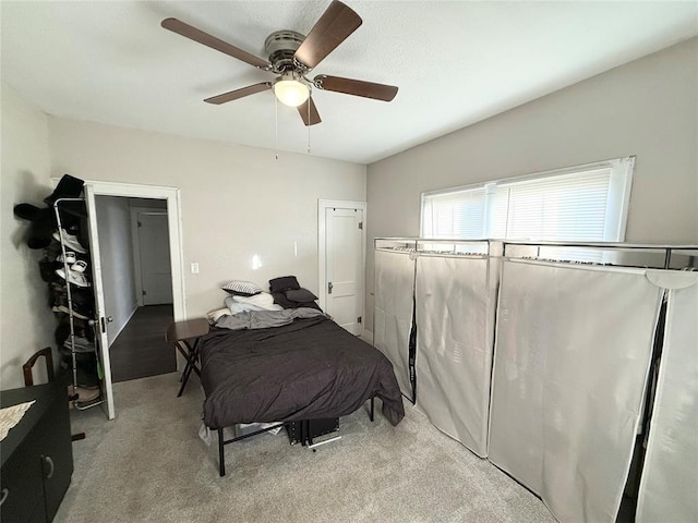 bedroom with light carpet and ceiling fan