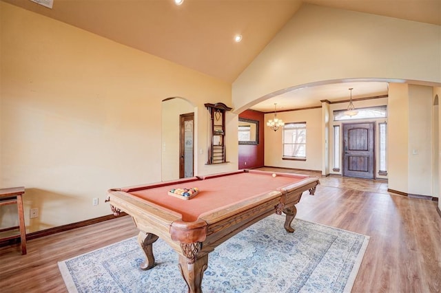 recreation room with billiards, high vaulted ceiling, and light hardwood / wood-style flooring