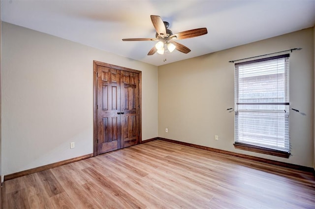 unfurnished bedroom featuring light hardwood / wood-style flooring, a closet, and ceiling fan