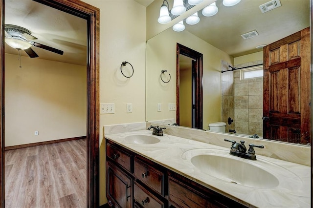 bathroom with vanity, hardwood / wood-style floors, ceiling fan, and toilet