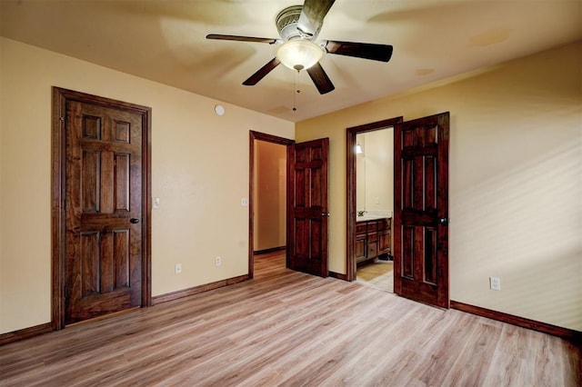 unfurnished bedroom with ensuite bath, ceiling fan, and light wood-type flooring