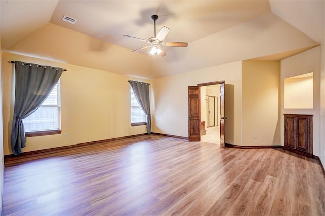 spare room with vaulted ceiling, ceiling fan, and light hardwood / wood-style floors