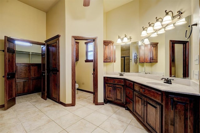 bathroom featuring vanity, tile patterned floors, and toilet