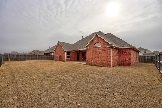 back of house featuring a yard and a patio area