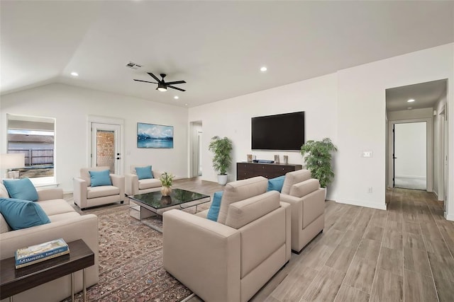 living room featuring vaulted ceiling, ceiling fan, and light hardwood / wood-style flooring