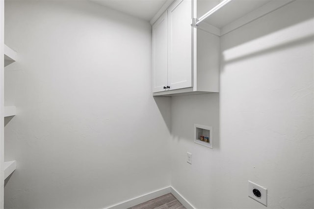 washroom featuring washer hookup, cabinets, wood-type flooring, and hookup for an electric dryer