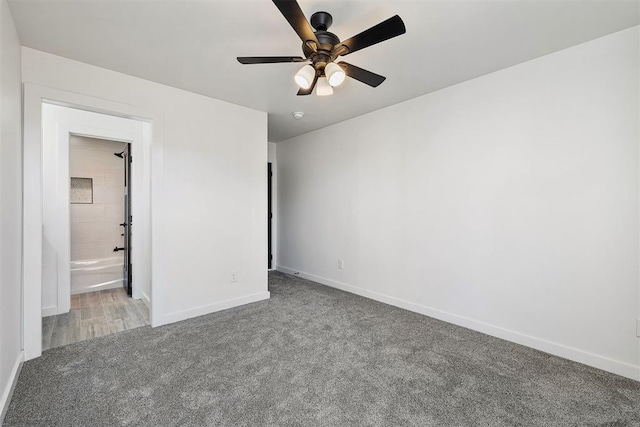 unfurnished bedroom featuring ceiling fan, light colored carpet, and ensuite bathroom