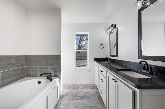 bathroom with a bathing tub and vanity