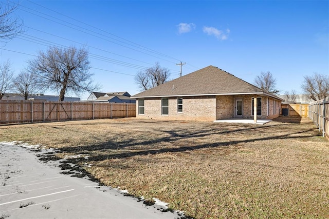 back of house with a patio area and a yard