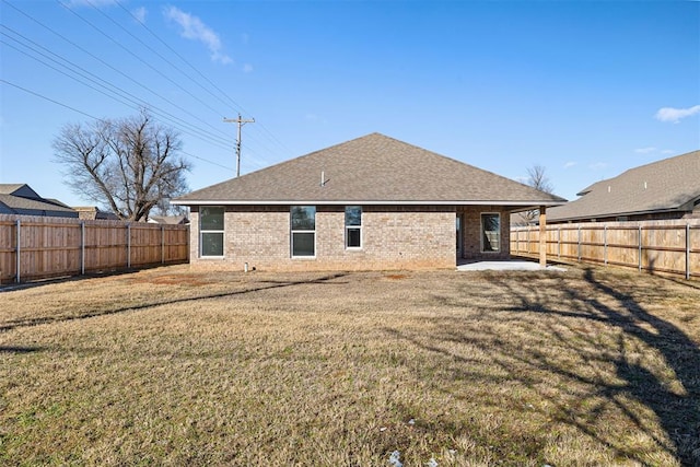 back of property with a patio and a yard