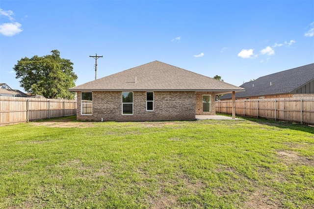 202 E Main St, Calumet, OK 73014 - rear view of house featuring brick siding, roof with shingles, and a patio area